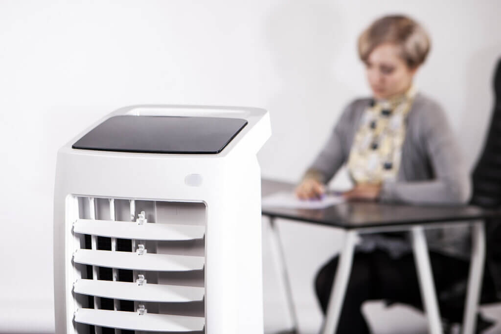 Woman sits behind cooler