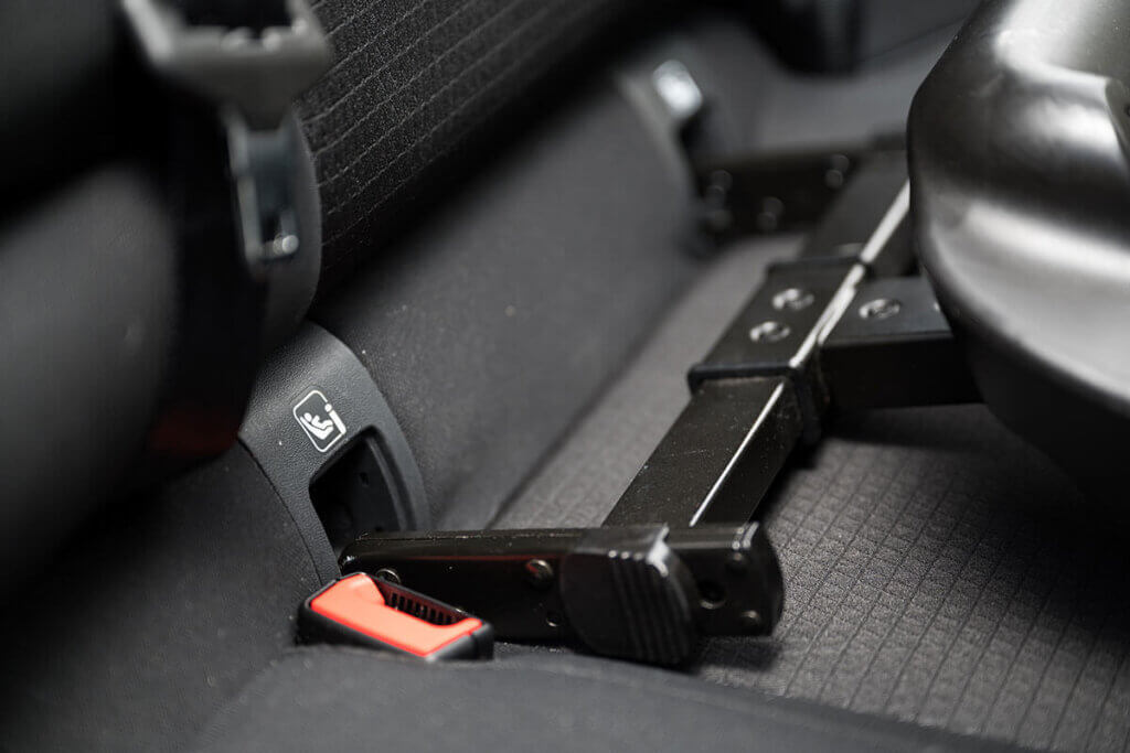 Isofix hooks are pushed into corresponding holders on the back seat in the car