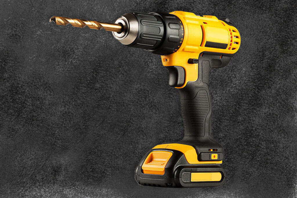cordless yellow impact driver on black background