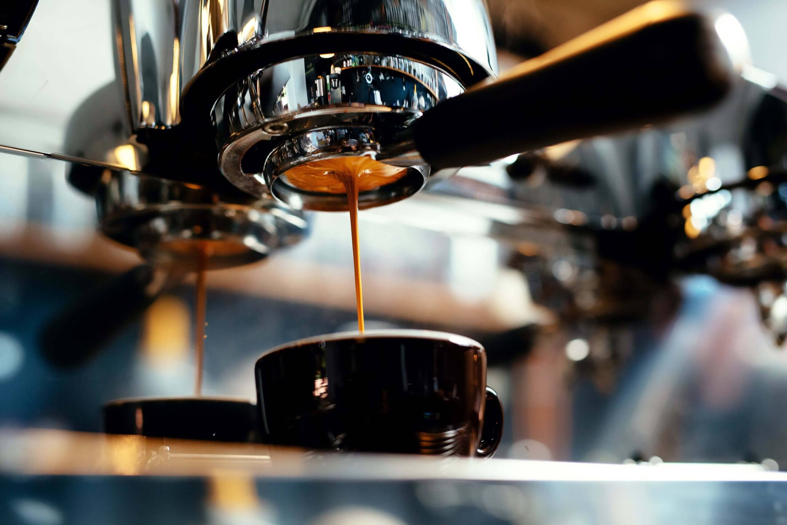 espresso is poured in coffe cup