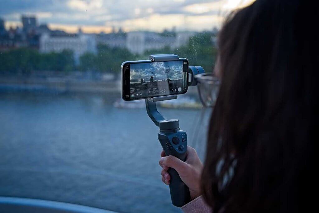 woman uses gimbal for smartphone