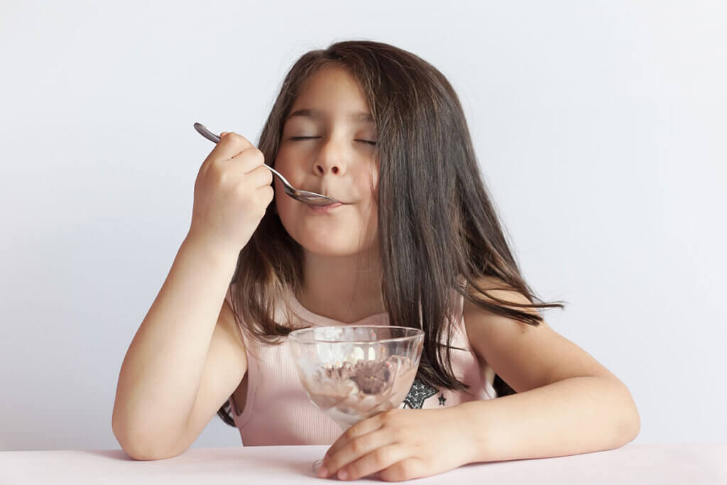 girl enjoys chocolate ice cream