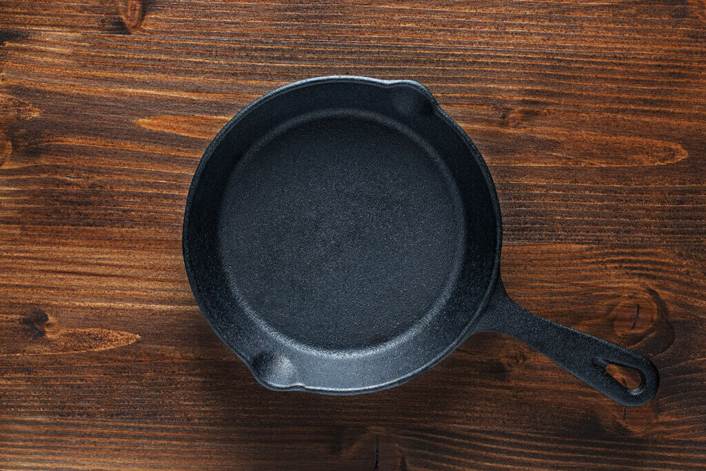 iron pan on wooden table