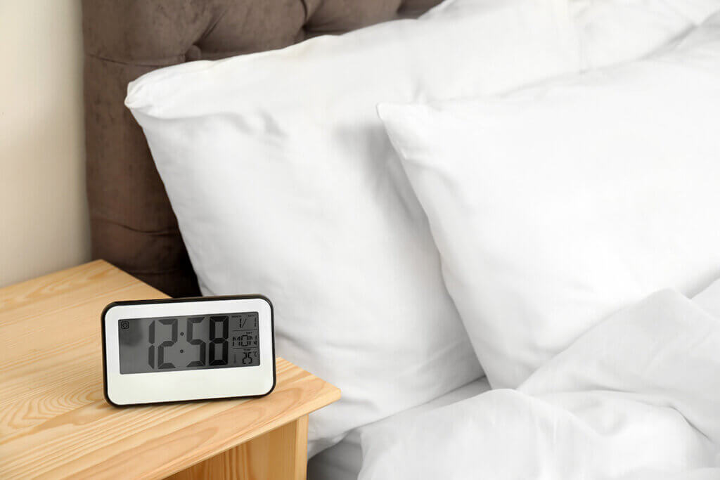 Alarm clock on the bedside table