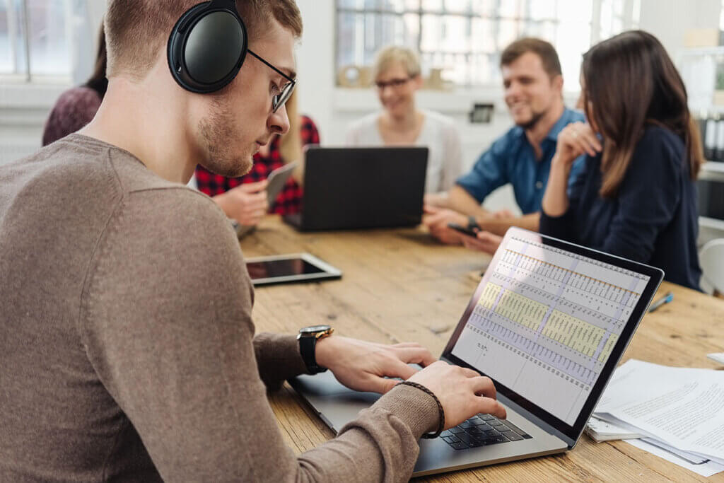 Young man with headphones on his laptop