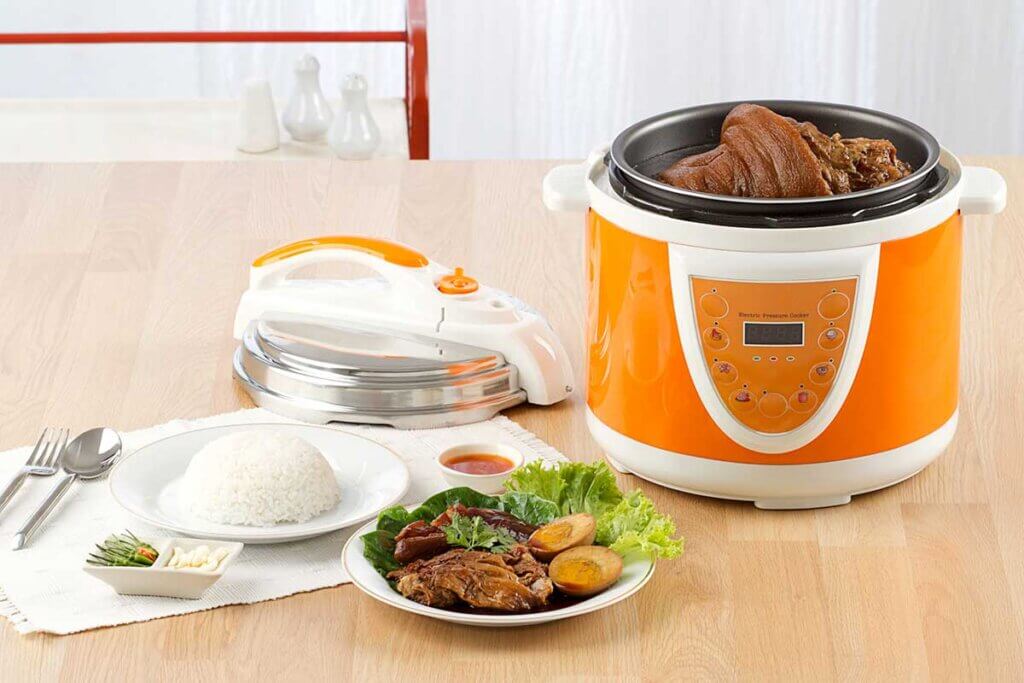 orange rice cooker with ingredients