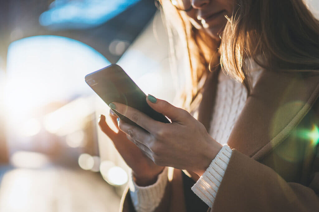 woman stop smartphone at the station