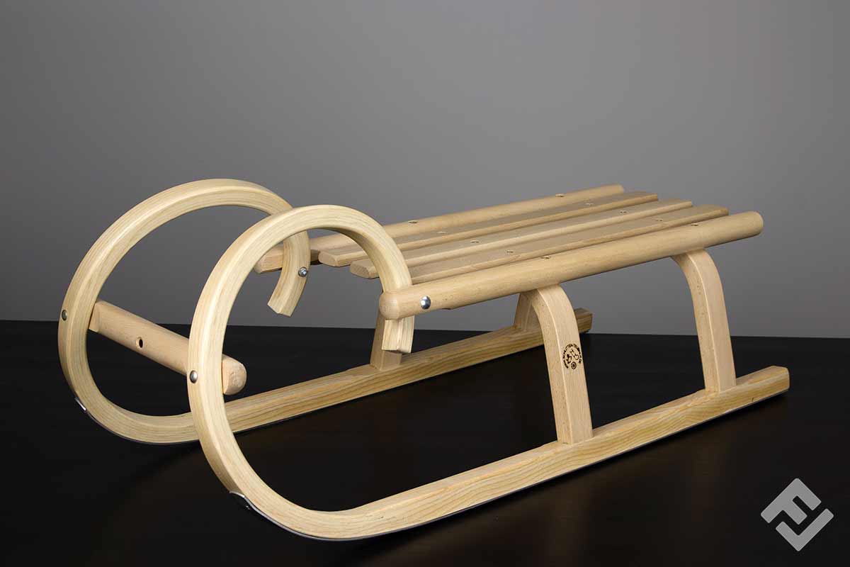 Horned wooden sled side view.
